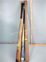 Two wooden baseball bats and aluminum bat