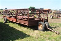 Moveable bale feeder with dolly wheel