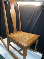 Wooden rocking chair with cane seat