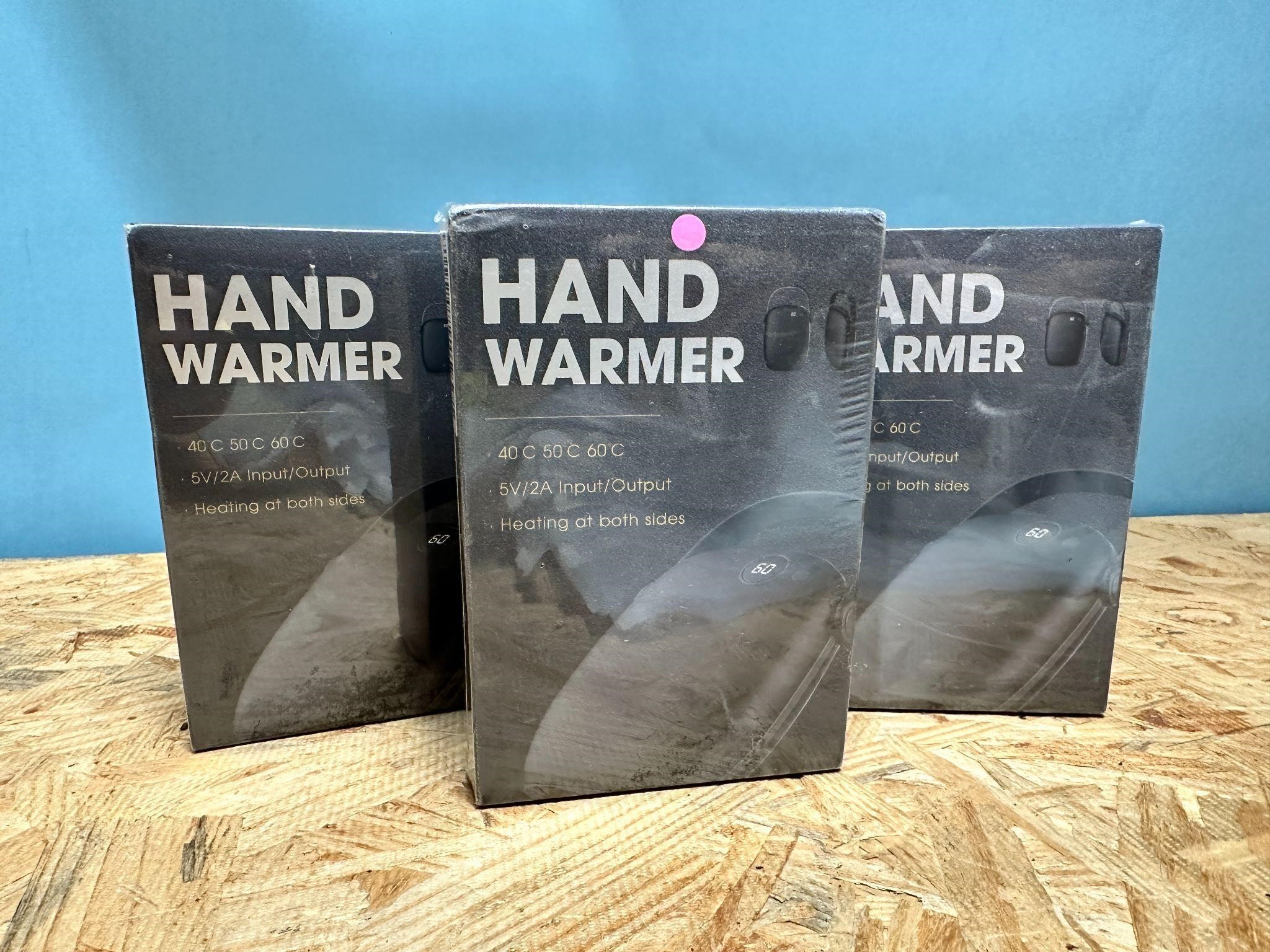Lot of three new electric hand warmers 2blk 1pnk