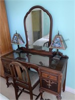 Vanity dresser with chair items on the dresser