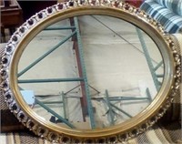 Oval mirror with gold frame