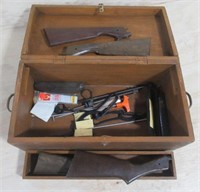 Wood box with various gun parts.
