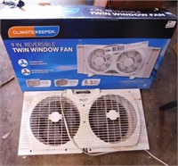 New 9" reversible twin window fan in box -