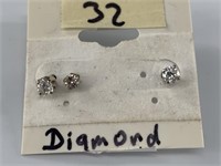 Pair of diamond studs with a small additional stud