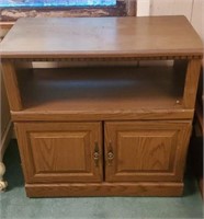 Brown wood table with 2 doors approx 28 inches