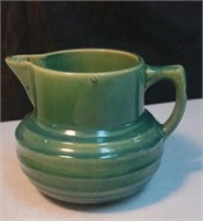 Pottery pitcher with shield 121 mark on bottom