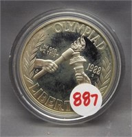 1988 Olympic proof silver dollar in capsule.