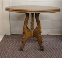 Antique oval table on carved base, 34.5 X 28.25"H