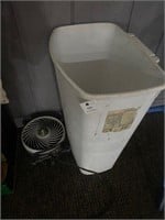 White trash bin, small electric fan