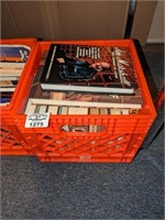 Plastic crate of assorted book titles