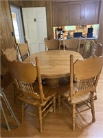 Oak Pedestal Table with 8 pressed back Chairs