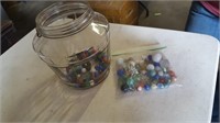 JAR AND BAG OF MARBLES