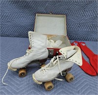 Antique roller skates in metal box
