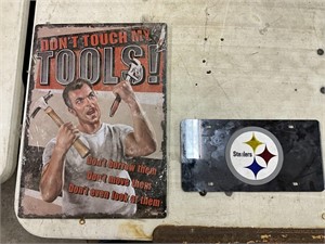 Metal sign and Steelers license plate