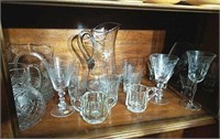 Crystal and other glassware on bottom shelf