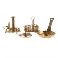 Four brass lighting articles and standish