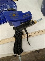 Small sandblaster gun with bucket of abrasive