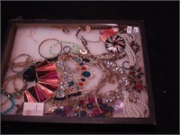 Container of costume jewelry including Avon