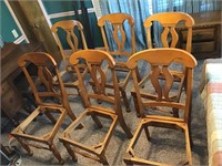 Six wooden chairs w seat cut outs.