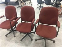 3 BURGANDY OFFICE CHAIRS WITH ARMS ON CASTORS