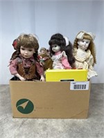 Assortment of porcelain dolls, some have stands
