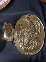 Brass bird, ram key hanging.