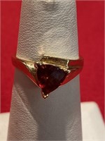 Garnet ring. Set in gold tone. Size 6 1/2.
