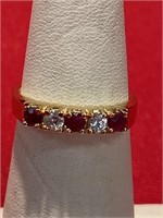 Red and white CZ ring. Set in gold tone. Size 6