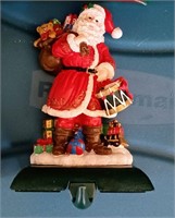 Four vintage cast iron Santa stocking holders