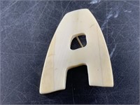 Unique walrus ivory letter A pin probably produced