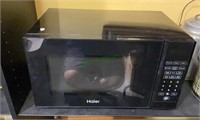 Haier brand microwave oven - black in color with a