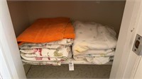 Shelf lot of sheets and a towel