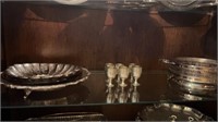 Shelf of silver plate platters , goblets and more