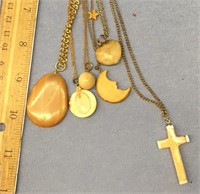 Lot of fossilized ivory pendants on gold tone chai
