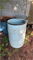 Plastic blue barrel, 2 metal barrels full of