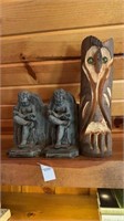 One wooden statue and two stone book holders