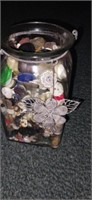 Square bottom jar filled with buttons