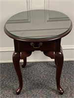 Mahogany Oval Queen Anne style table with a glass