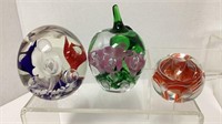 (3) Art glass paper weights. One is marked