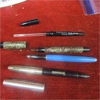 lot of vintage pens and thermometer.