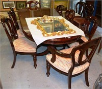 Dining suite comprising an oval extension table,