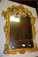Gilt resin framed ornate wall mirror,