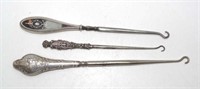 Three various vintage silver handle boot hooks