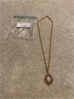 Gold colored chained necklace with pendant