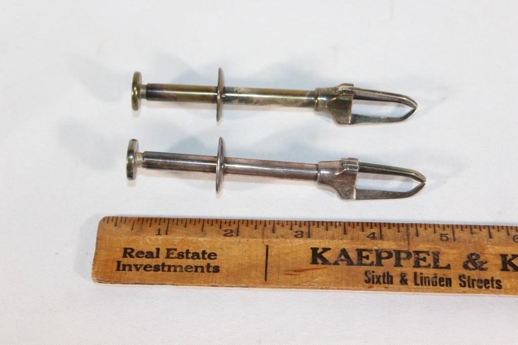 Two Antique seed pitting gadget