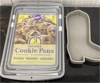 Unopened 3 Piece cookie sheet set & Boot cake pan