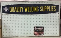Welding Supplies sign on workshop pegboard