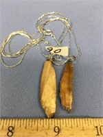 Lot of 2 fossilized ivory pendants            (a 7
