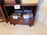 Wooden entertainment center on casters, has